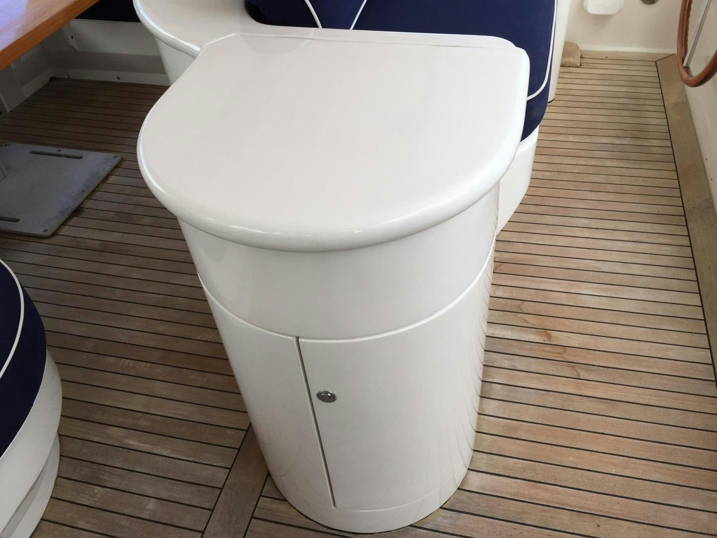 a toilet with a wooden floor aboard UNZIPPED Yacht for Sale