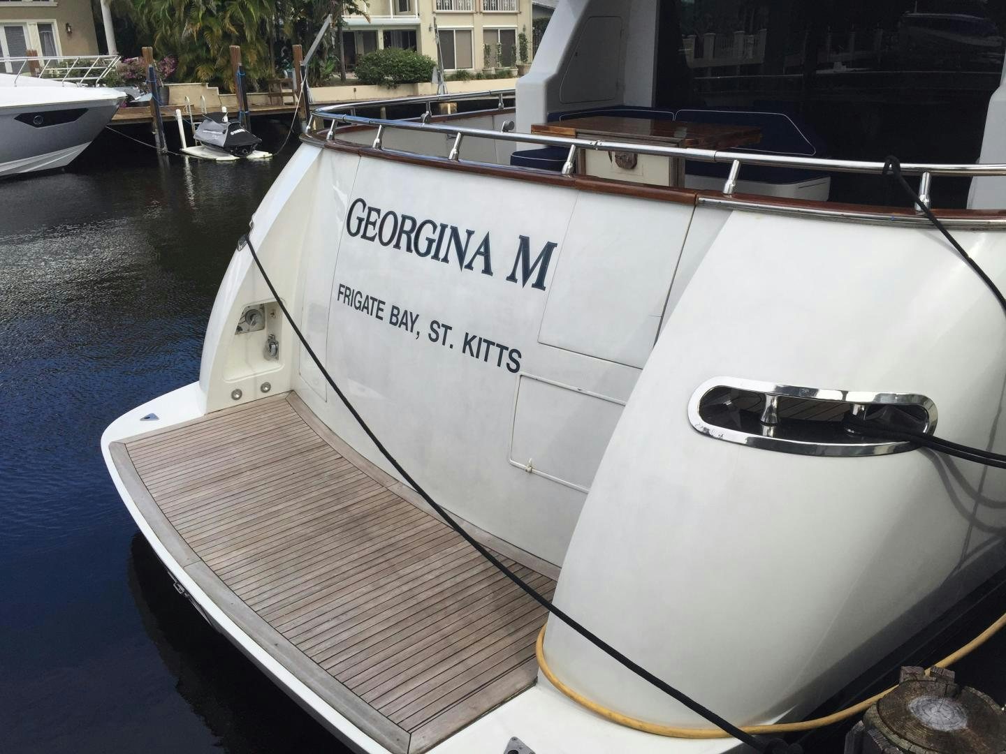 a white boat in a harbor aboard UNZIPPED Yacht for Sale
