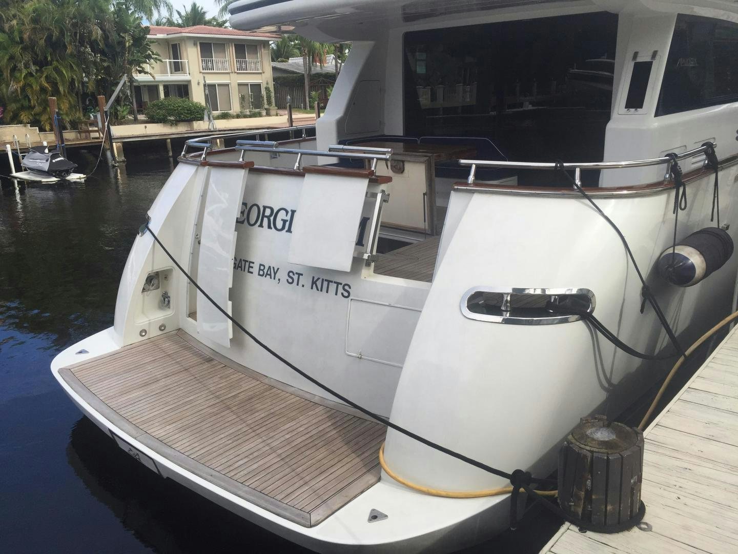 a boat docked at a pier aboard UNZIPPED Yacht for Sale