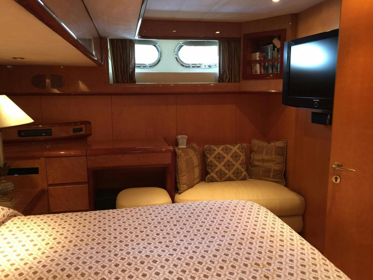 a room with a bed and a tv aboard UNZIPPED Yacht for Sale