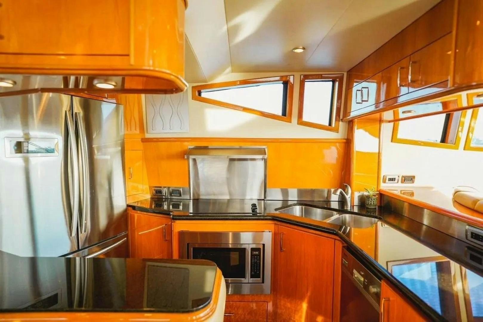 a kitchen with a stainless steel refrigerator aboard STARTING OVER Yacht for Sale