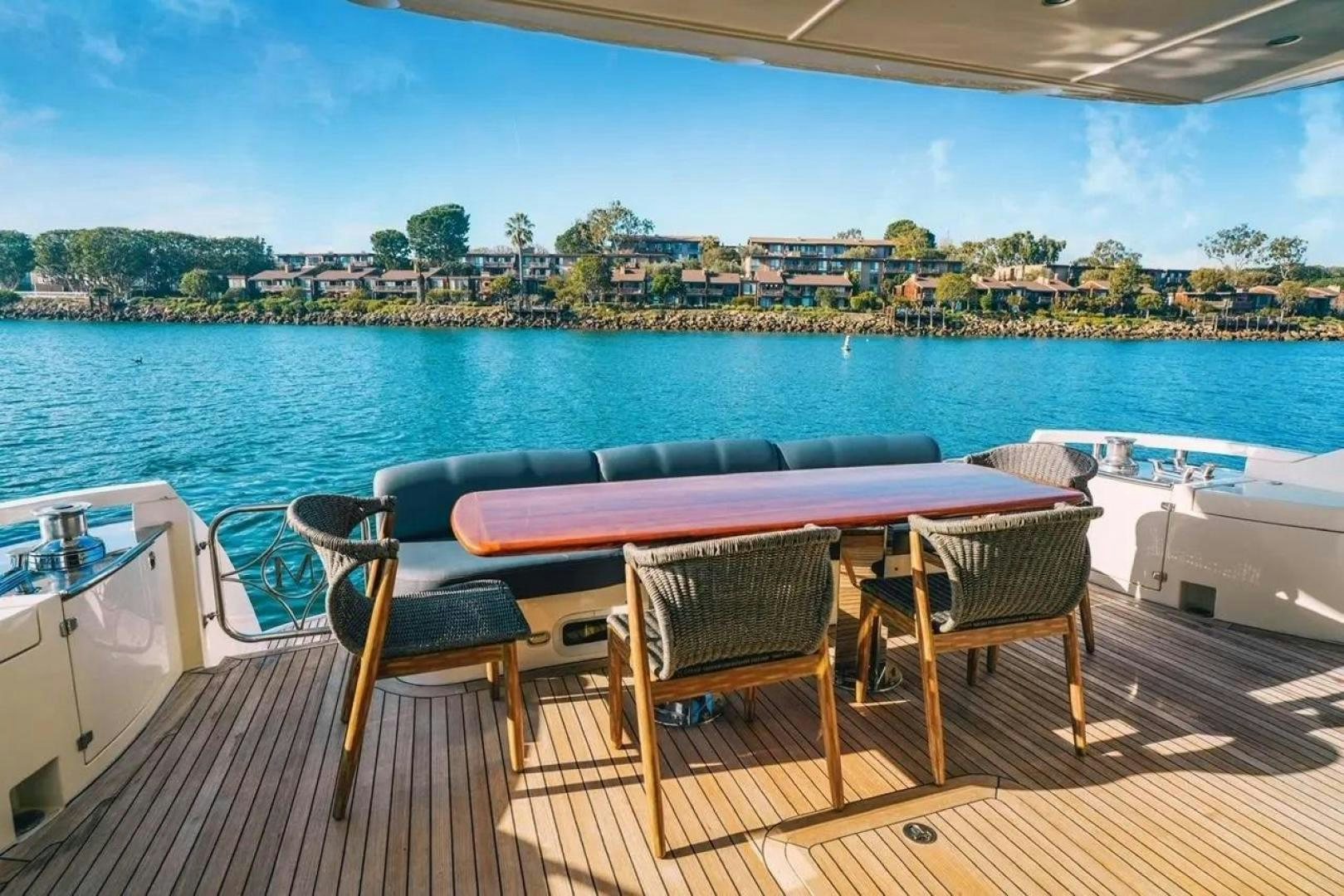 a table and chairs on a deck overlooking a body of water aboard STARTING OVER Yacht for Sale