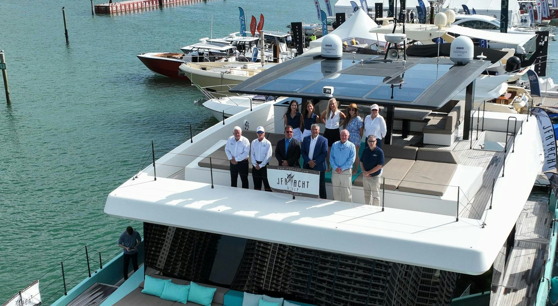 a group of people standing on a boat aboard ROCK STAR 2.0 Yacht for Sale