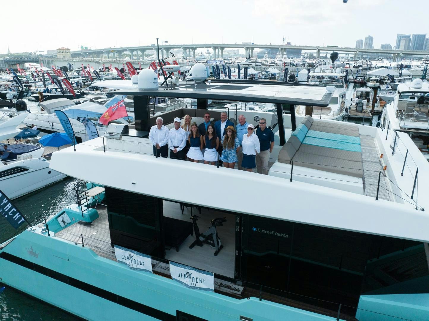 a group of people standing on a boat in a harbor aboard ROCK STAR 2.0 Yacht for Sale
