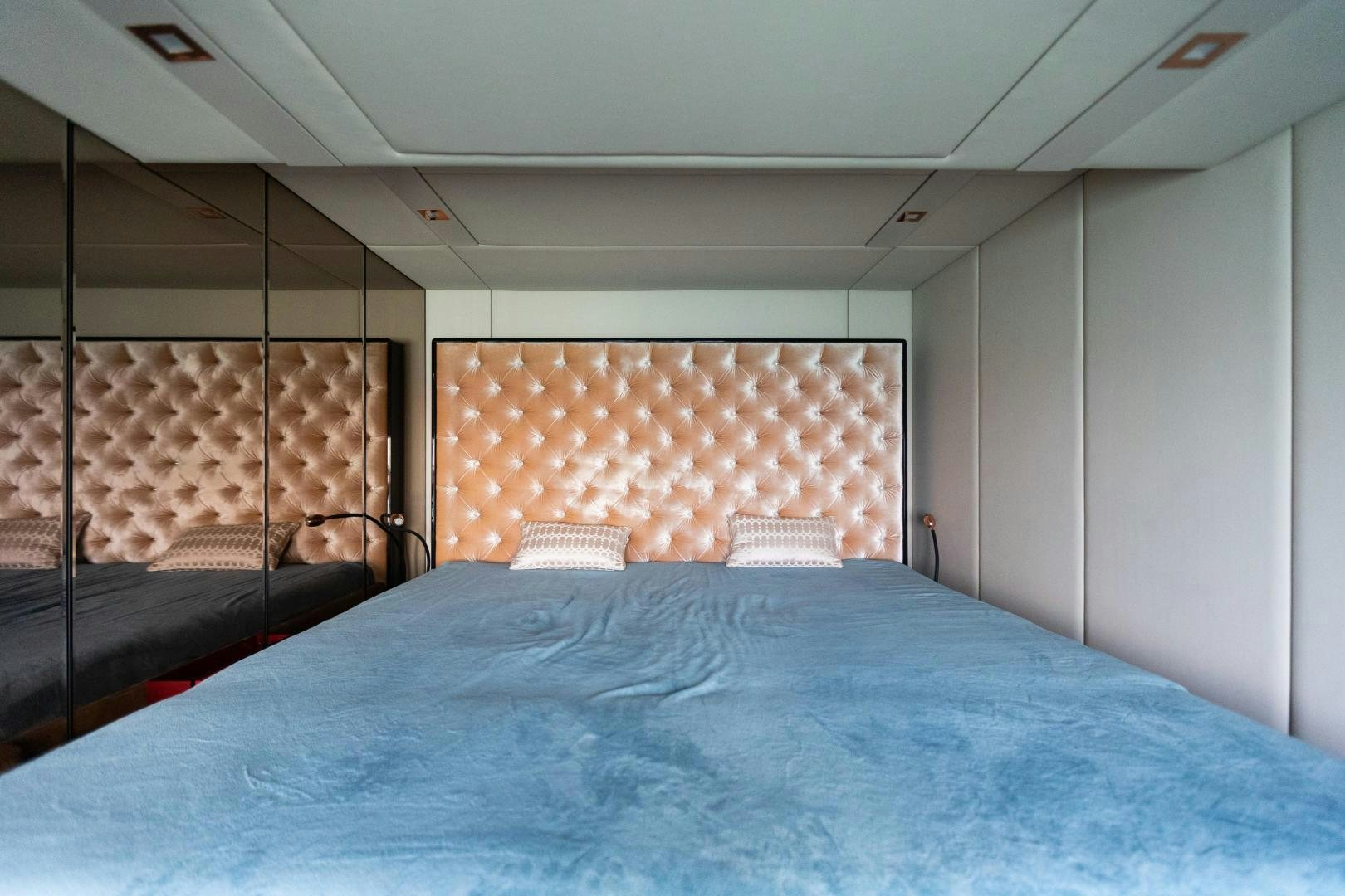 a bed with blue sheets aboard ROCK STAR 2.0 Yacht for Sale