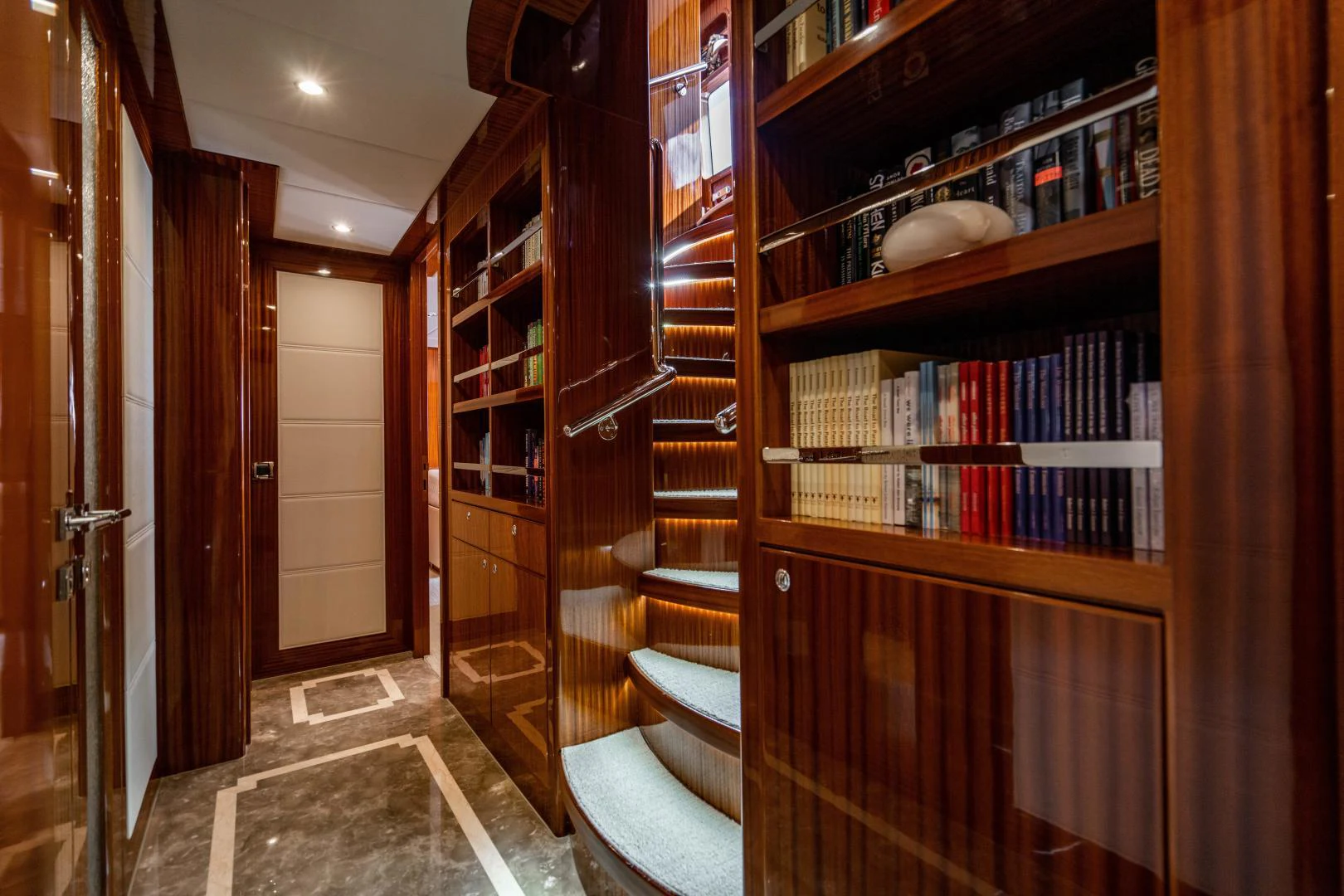 a room with a bookshelf and a rug aboard RENAISSANCE Yacht for Sale
