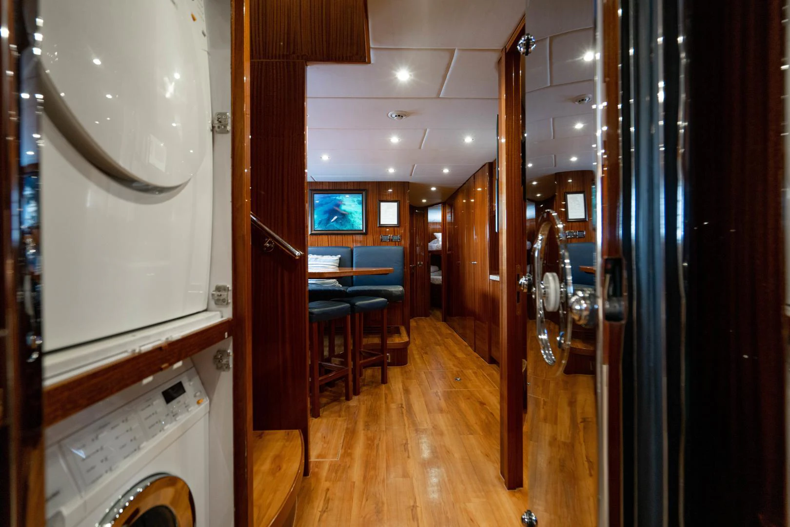 a room with a wood floor and a large mirror aboard RENAISSANCE Yacht for Sale