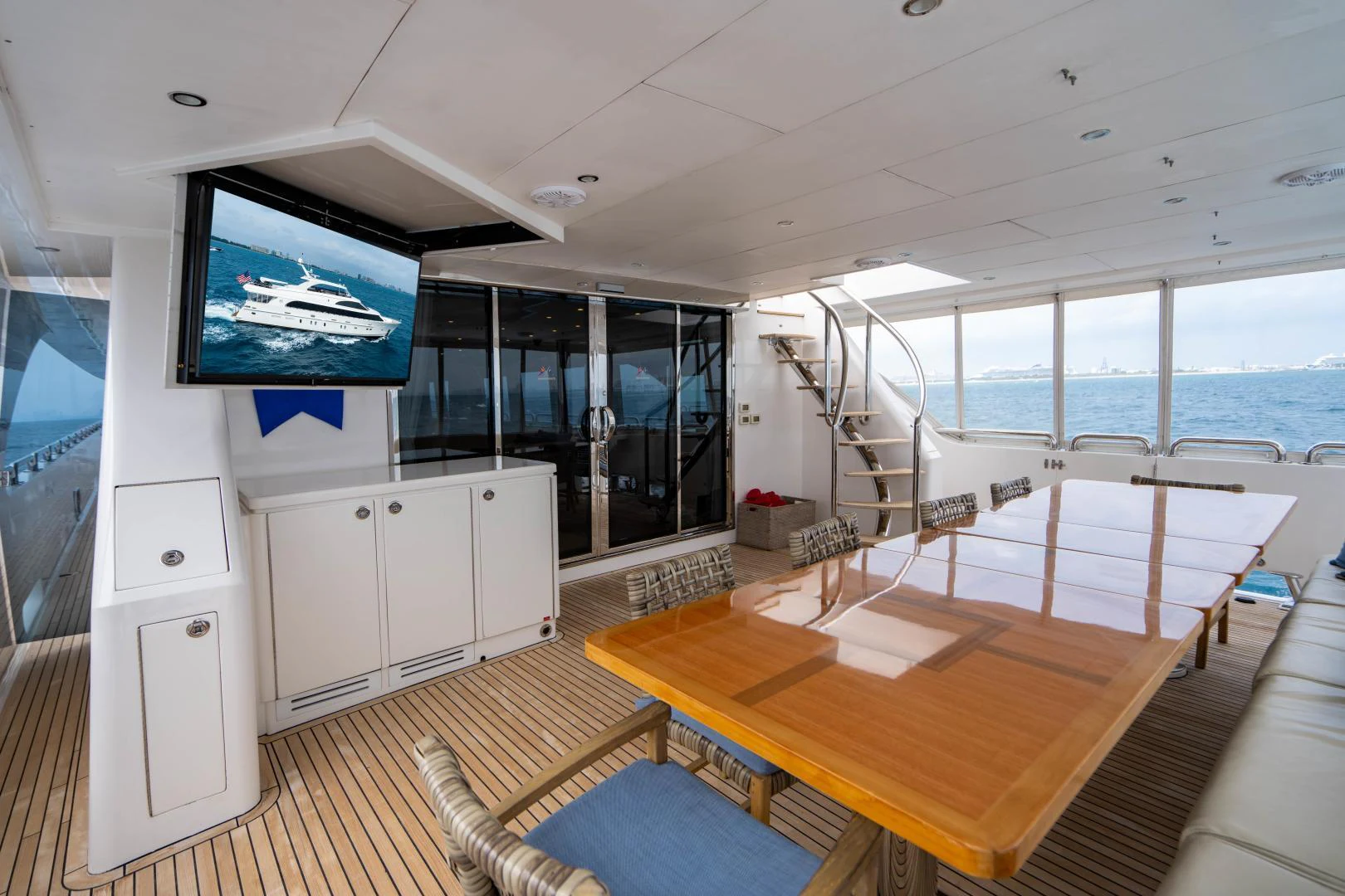 a room with a table and tv aboard RENAISSANCE Yacht for Sale