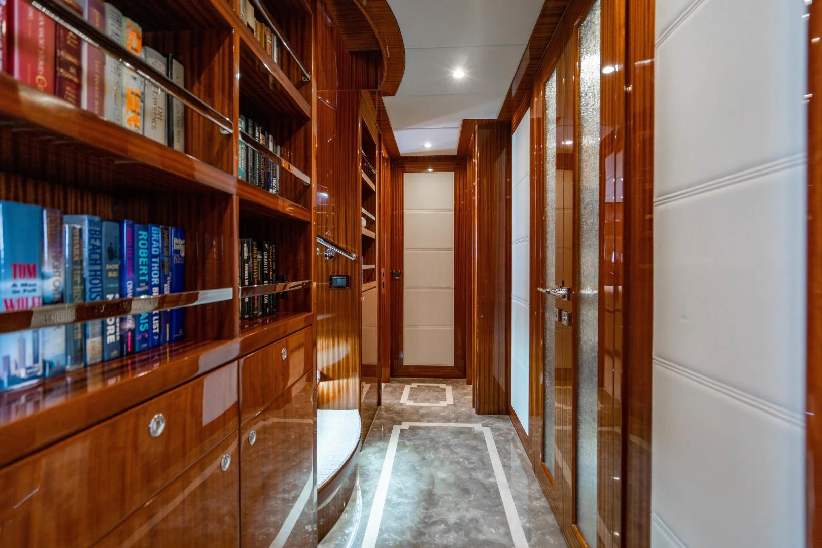 a hallway with bookshelves aboard RENAISSANCE Yacht for Sale