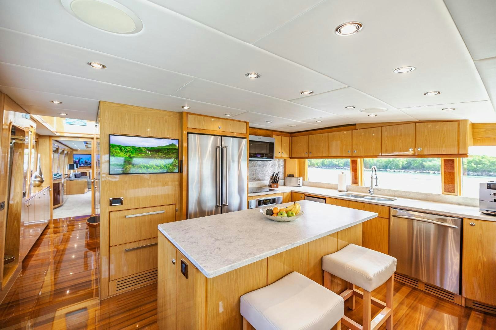 a kitchen with wooden cabinets aboard GRATITUDE Yacht for Sale