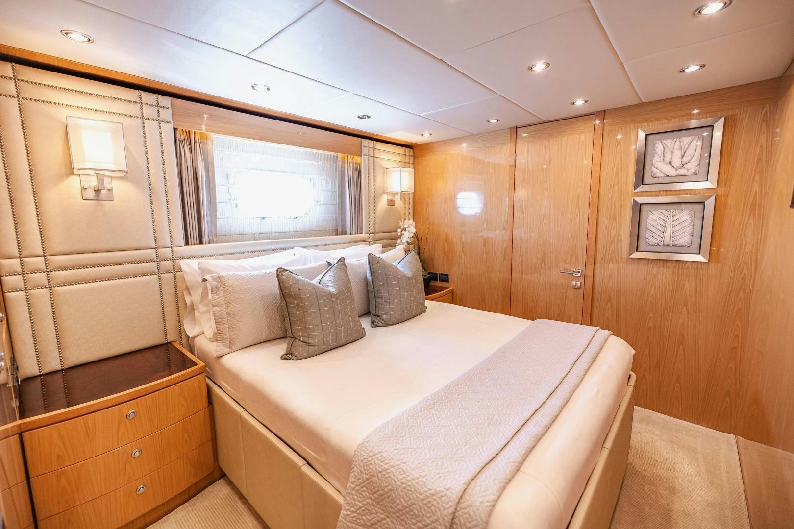 a room with a bed and a dresser aboard GRATITUDE Yacht for Sale