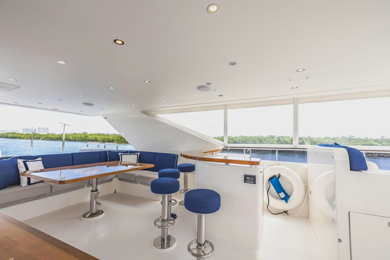 a room with tables and chairs aboard GRATITUDE Yacht for Sale