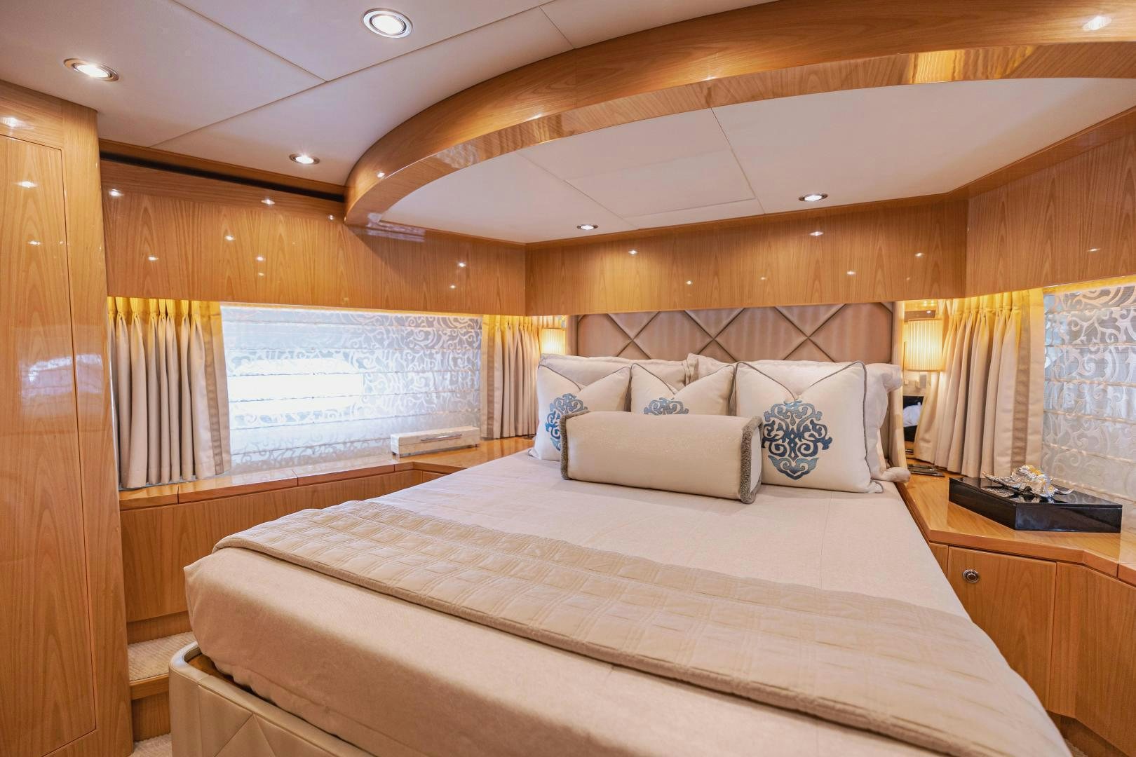 a bed with a white bed spread aboard GRATITUDE Yacht for Sale
