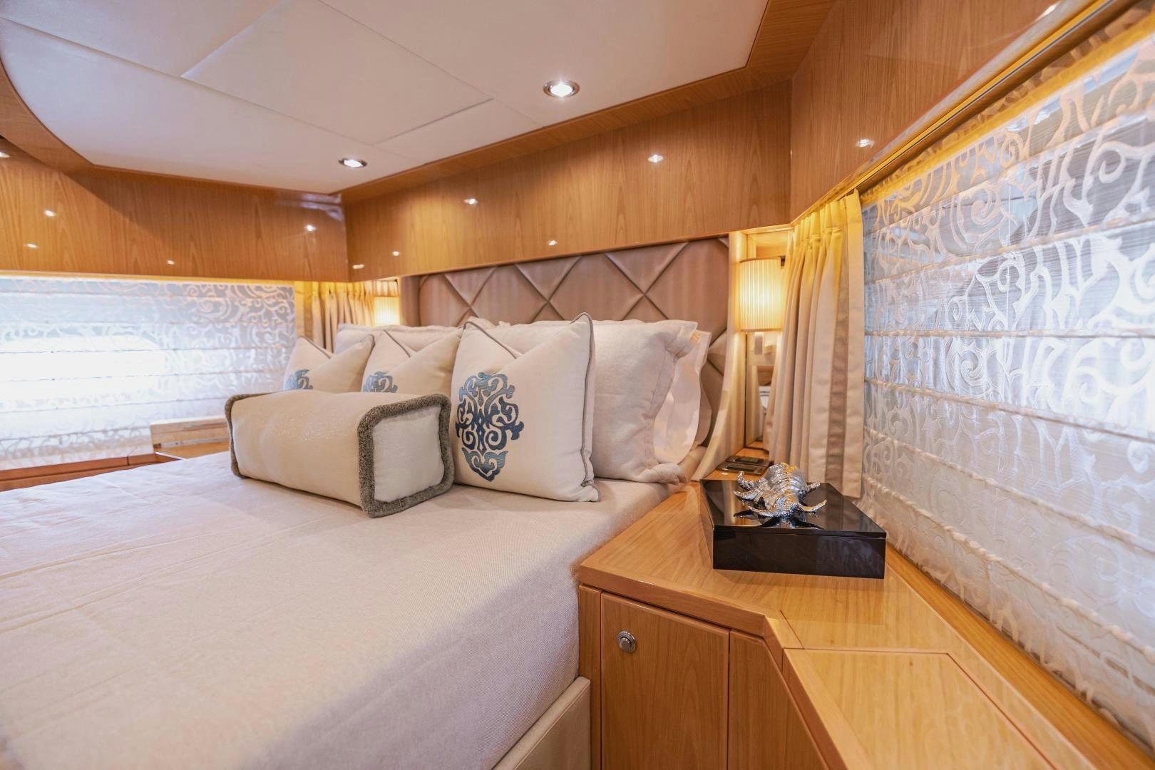 a bed with a white bed spread aboard GRATITUDE Yacht for Sale