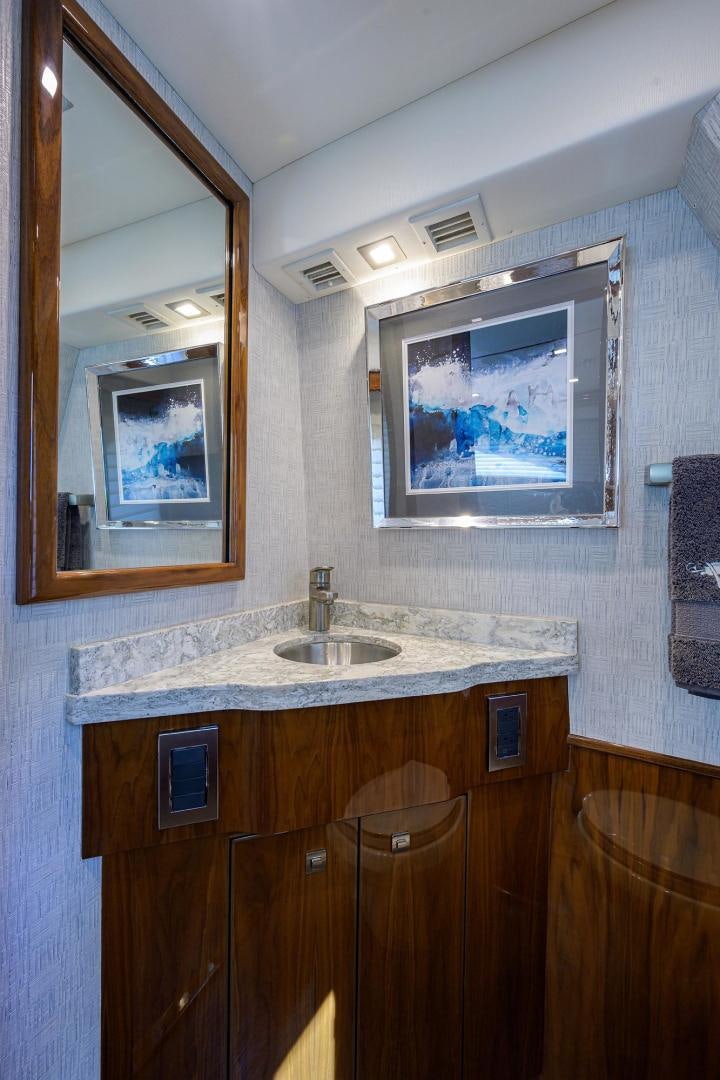 a bathroom with a sink and a mirror aboard QUICK RAISE Yacht for Sale
