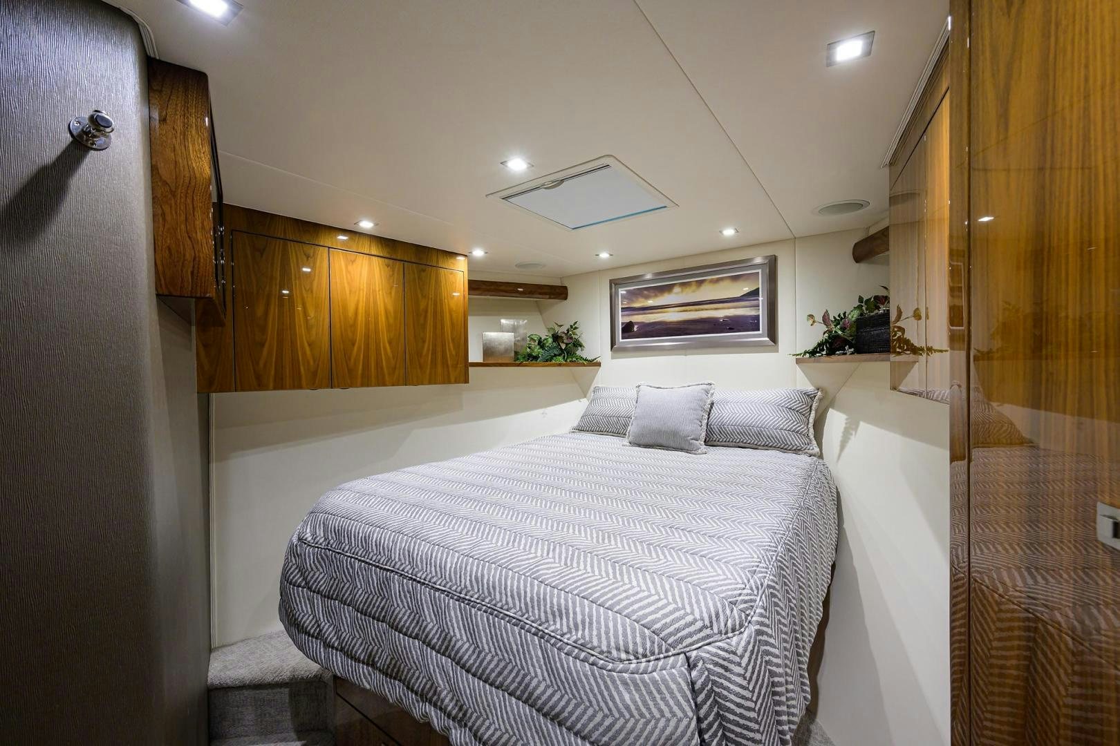 a room with a bed and a wood cabinet aboard QUICK RAISE Yacht for Sale