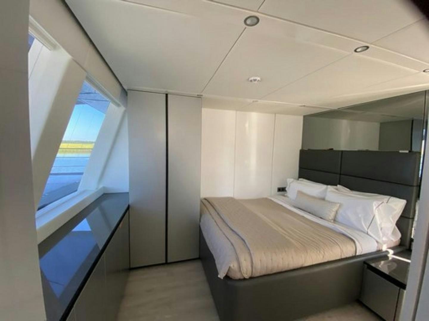 a room with a bed and a window aboard EMMILIZA Yacht for Sale