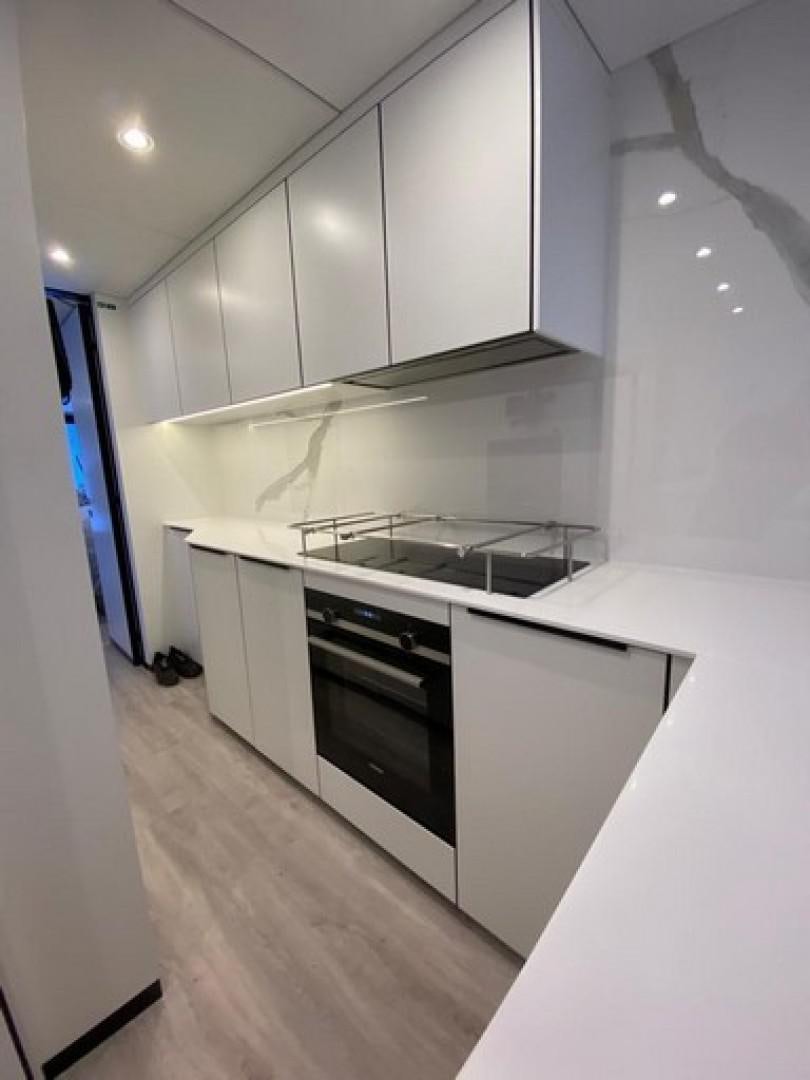 a kitchen with white cabinets aboard EMMILIZA Yacht for Sale