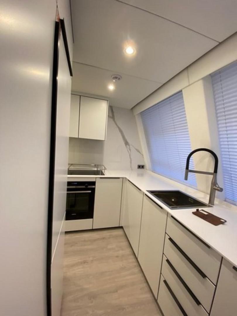 a kitchen with white cabinets aboard EMMILIZA Yacht for Sale