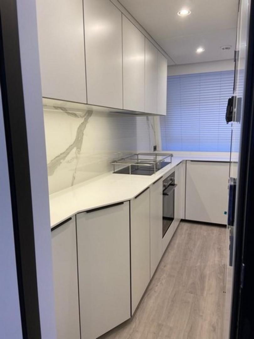 a kitchen with white cabinets aboard EMMILIZA Yacht for Sale