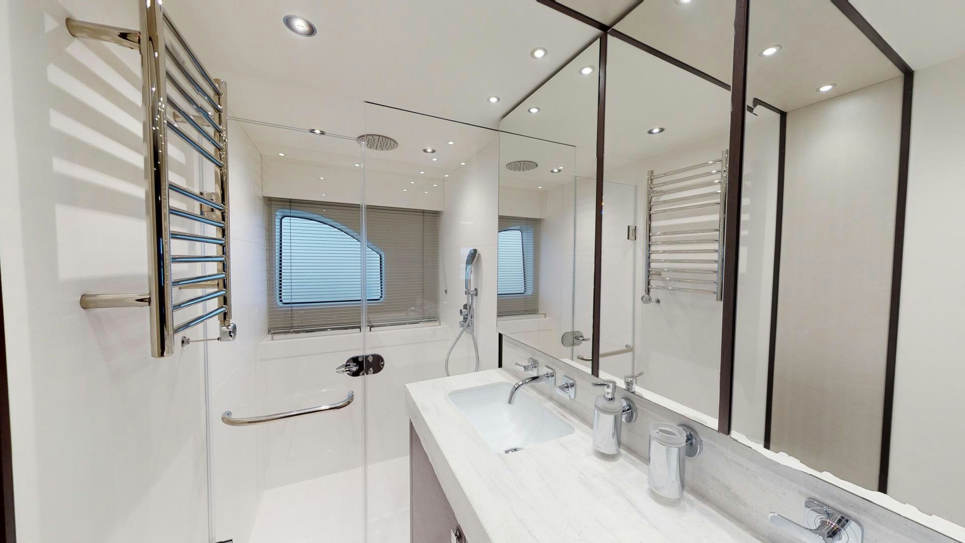 a bathroom with a large mirror aboard MOONLIGHT Yacht for Sale