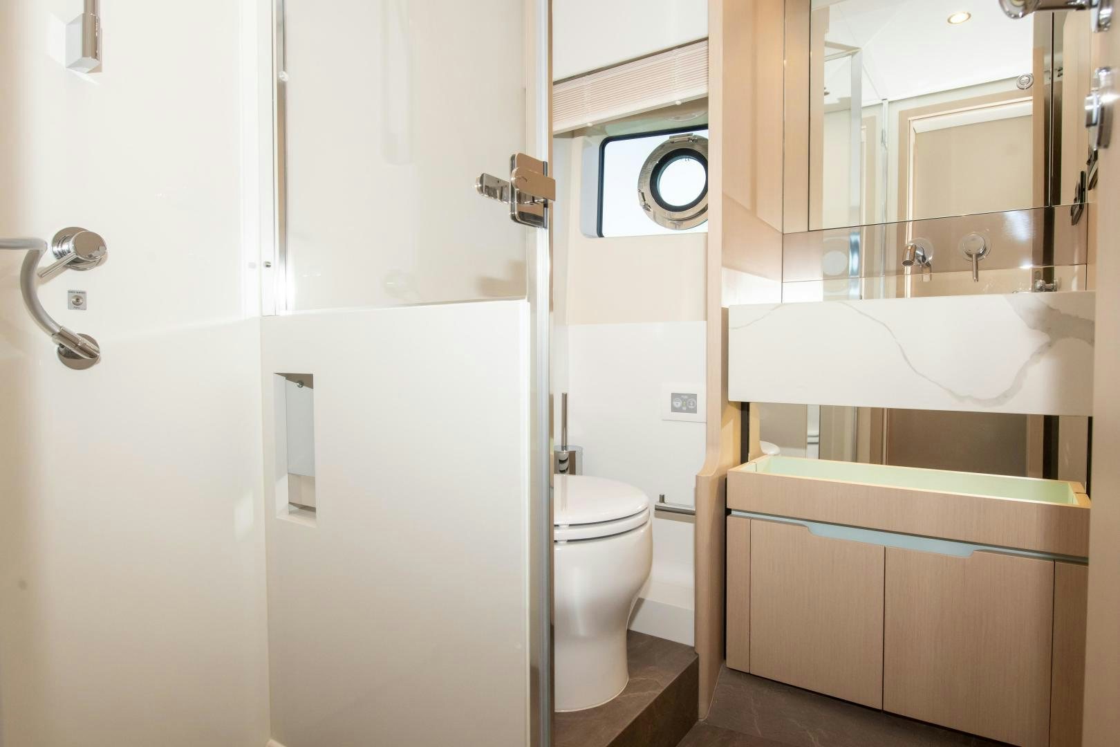 a bathroom with a toilet and a sink aboard CRIMSON Yacht for Sale