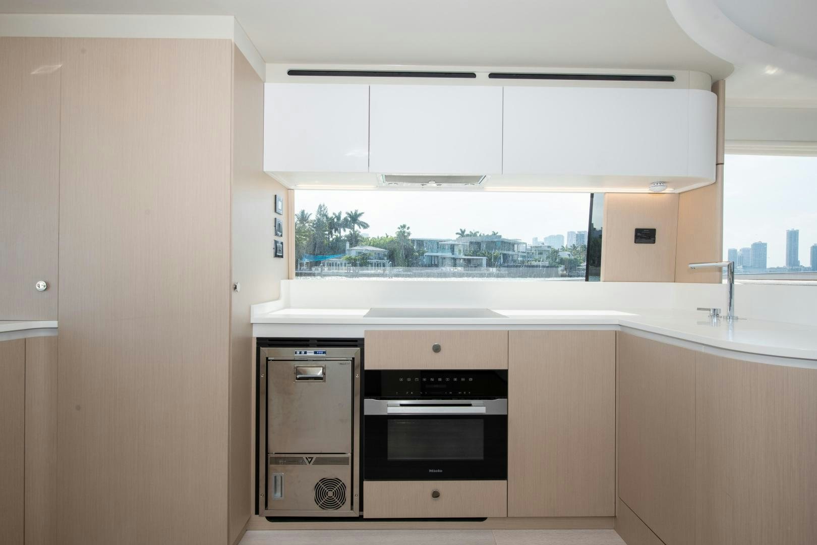 a kitchen with white cabinets aboard CRIMSON Yacht for Sale