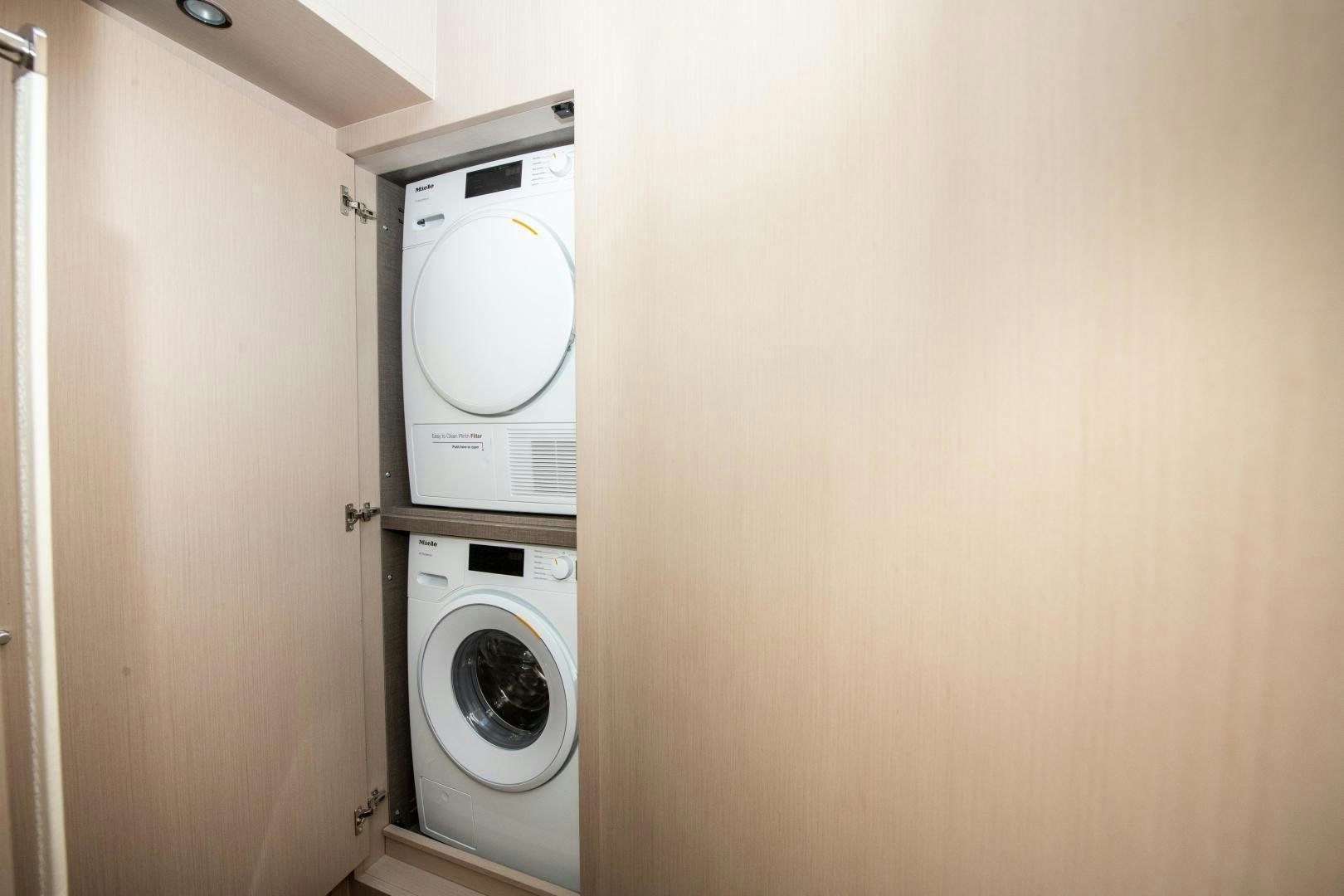 a closet with a washing machine and dryer aboard CRIMSON Yacht for Sale