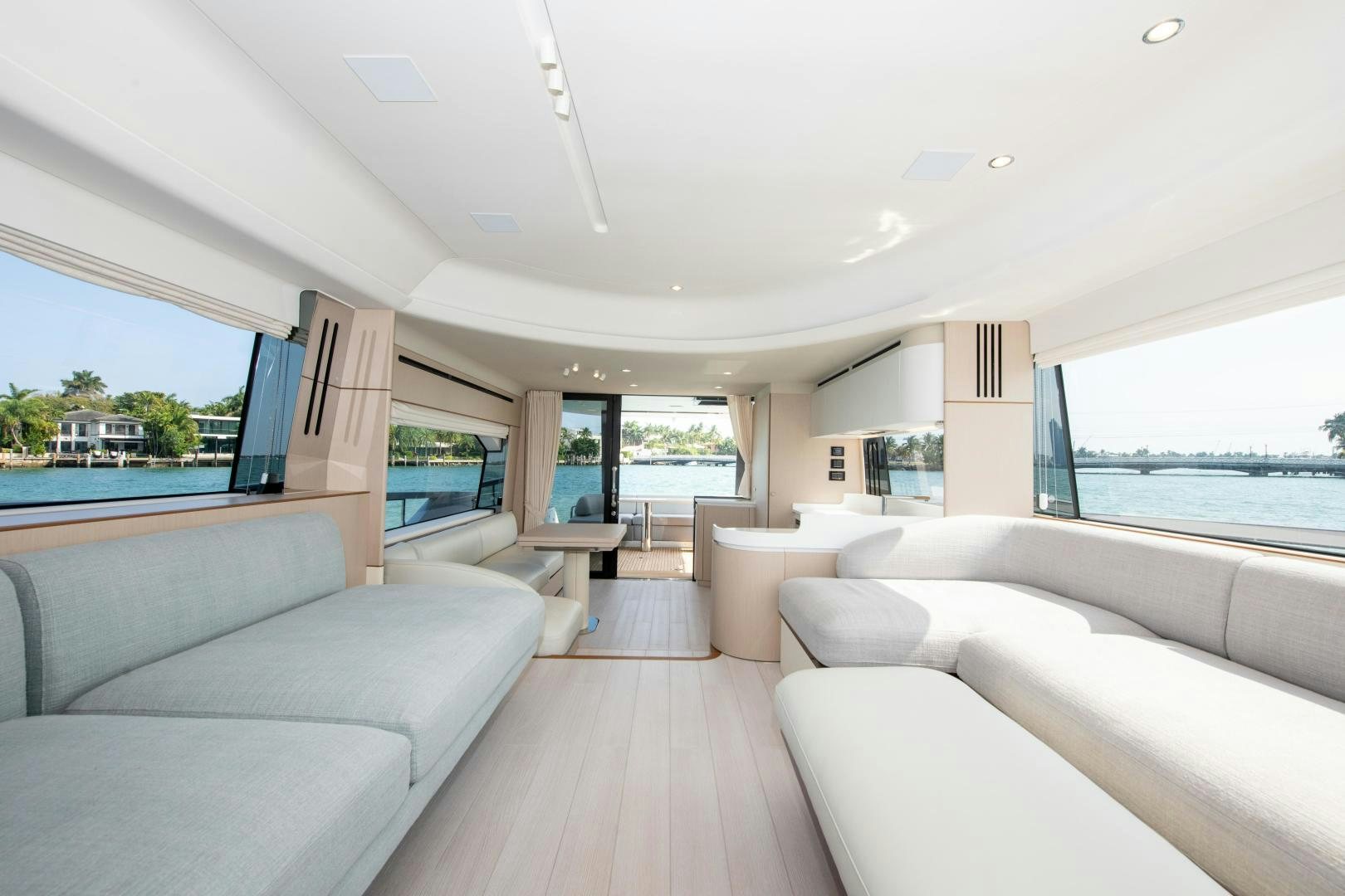 a living room with a large window aboard CRIMSON Yacht for Sale