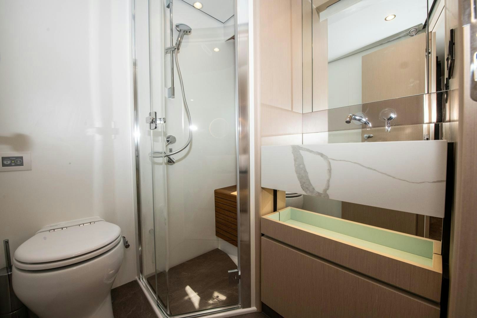 a bathroom with a toilet and bathtub aboard CRIMSON Yacht for Sale