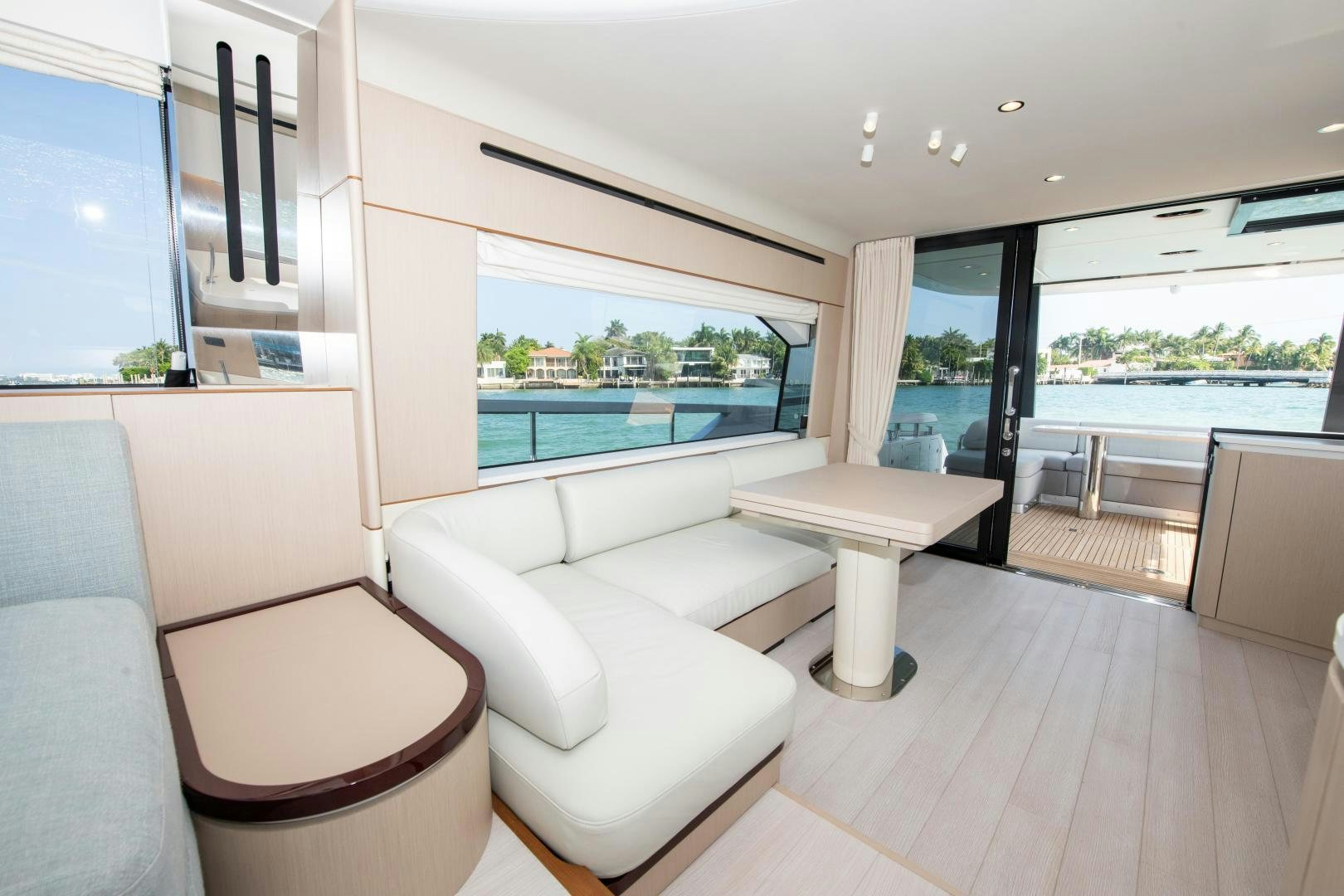 a living room with a large window aboard CRIMSON Yacht for Sale
