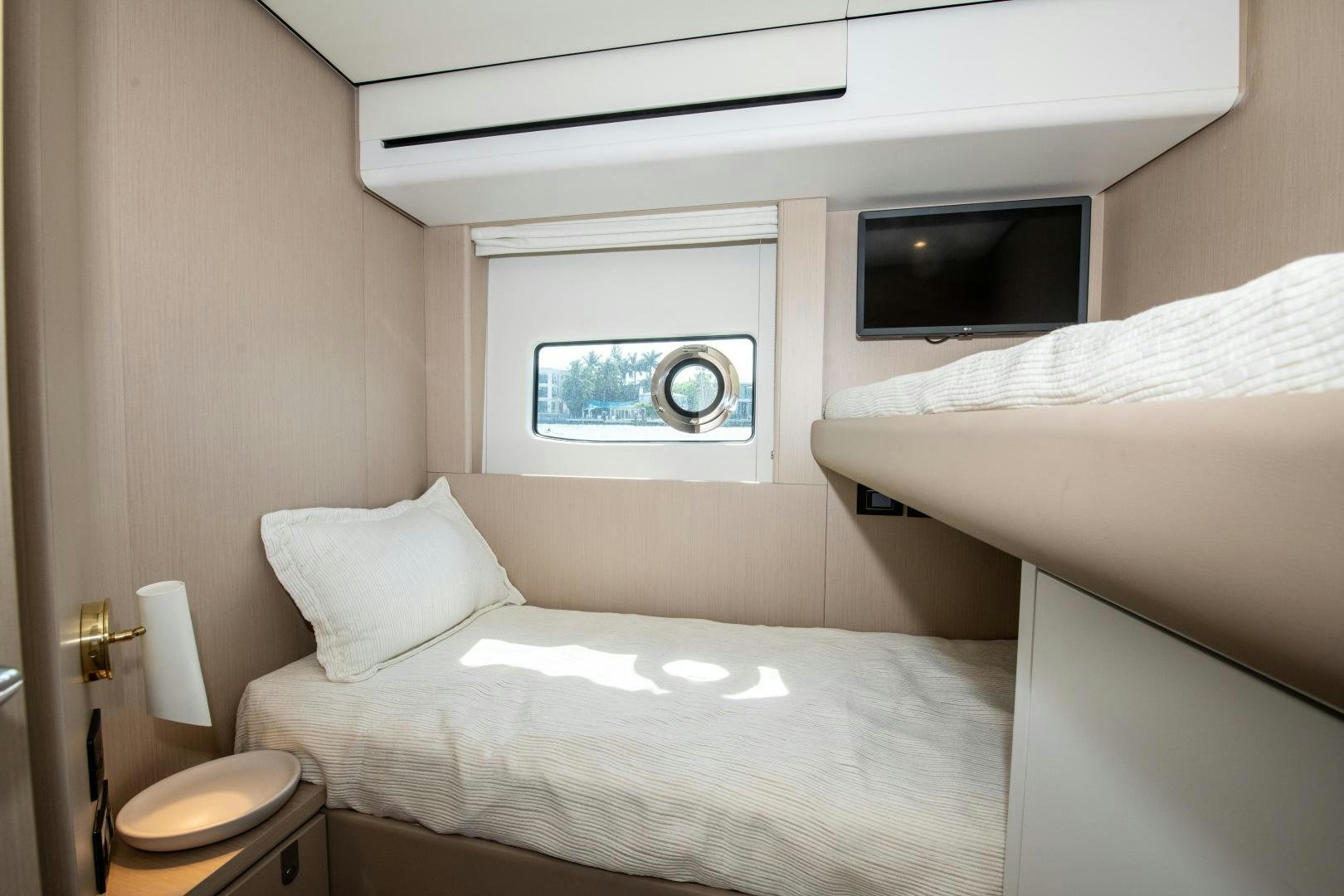 a bedroom with a bed and a television aboard CRIMSON Yacht for Sale