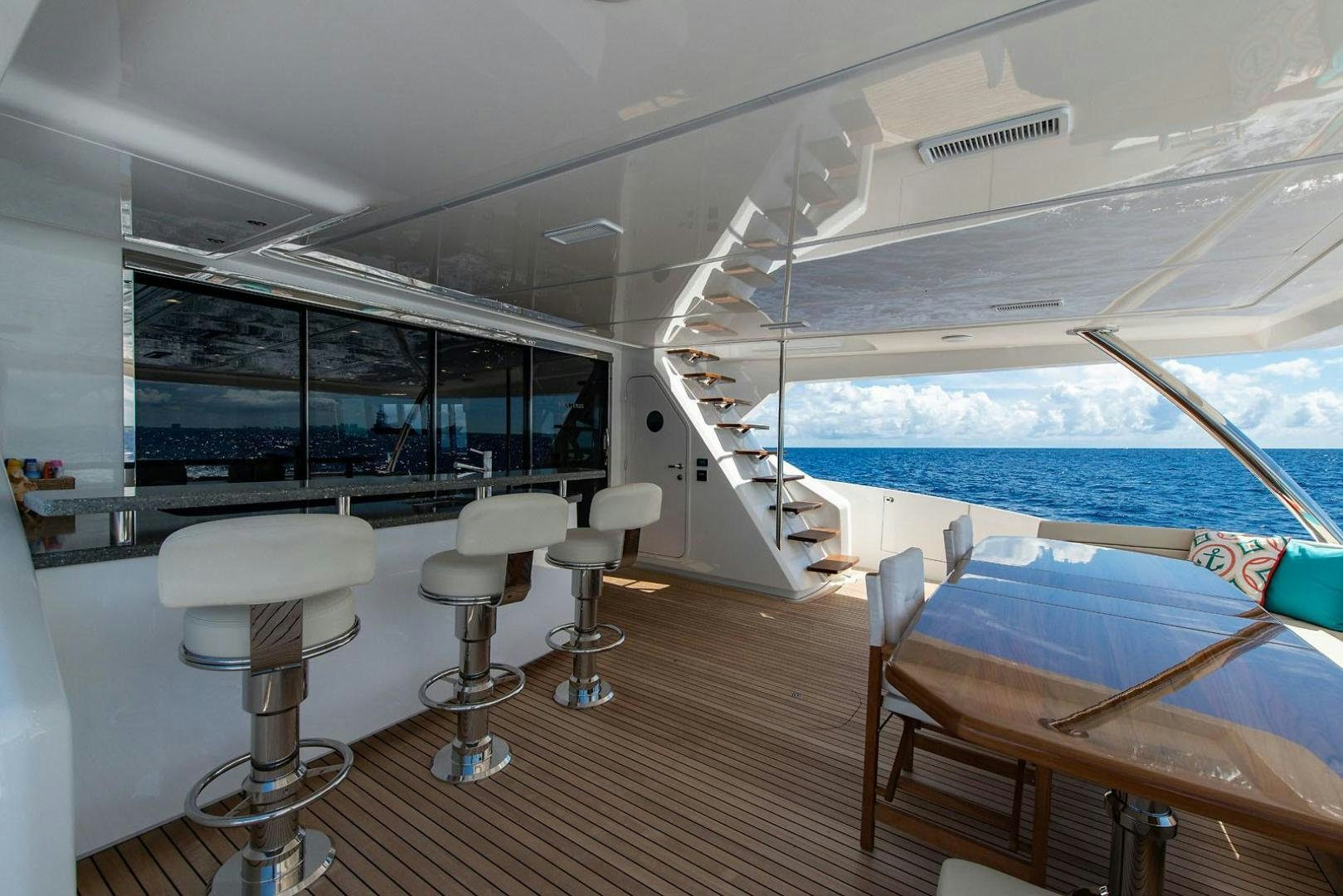 a room with a deck and chairs aboard OBSESSION Yacht for Sale