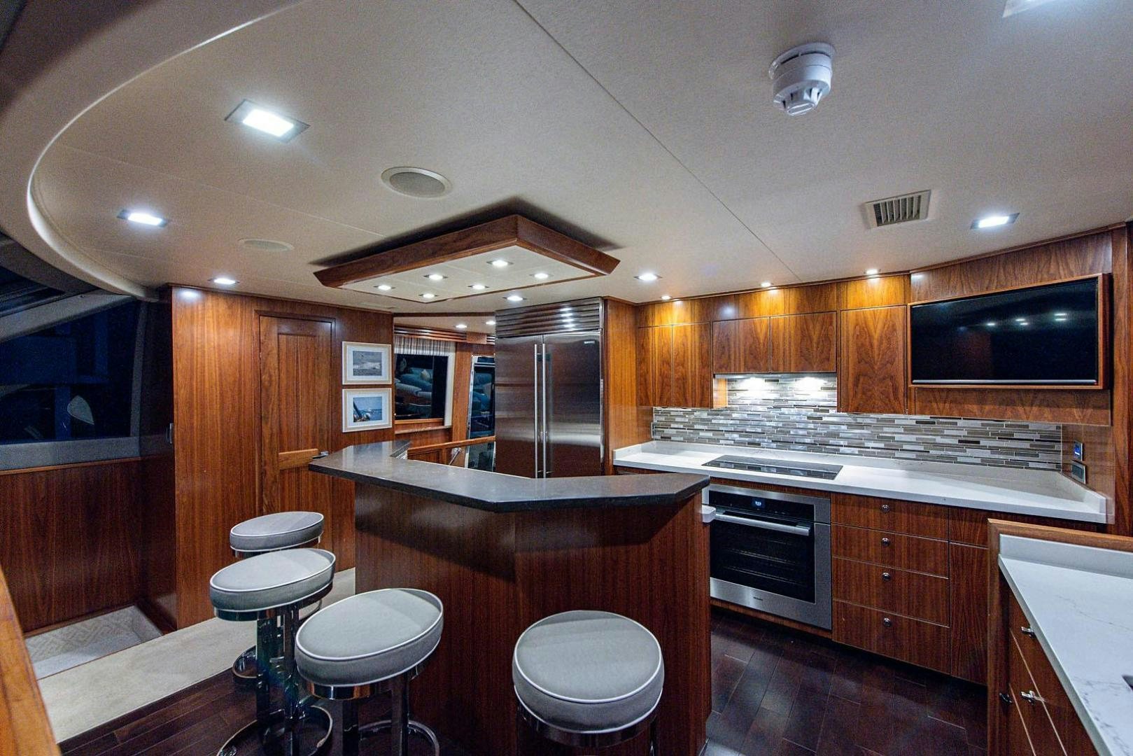 a kitchen with wooden cabinets aboard OBSESSION Yacht for Sale