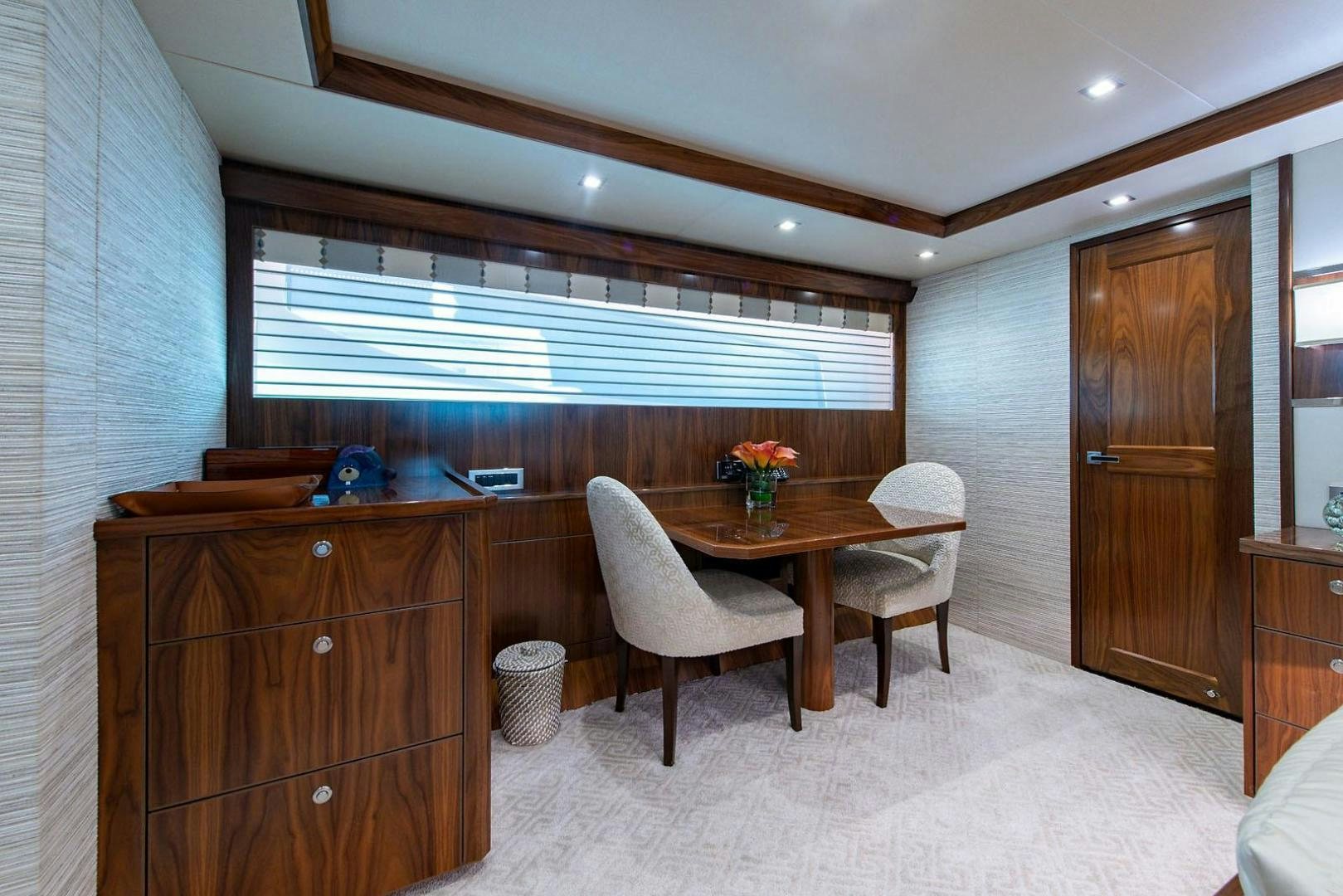 a room with a table chairs and a window aboard OBSESSION Yacht for Sale