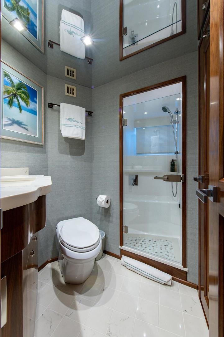 a bathroom with a toilet and a sink aboard OBSESSION Yacht for Sale