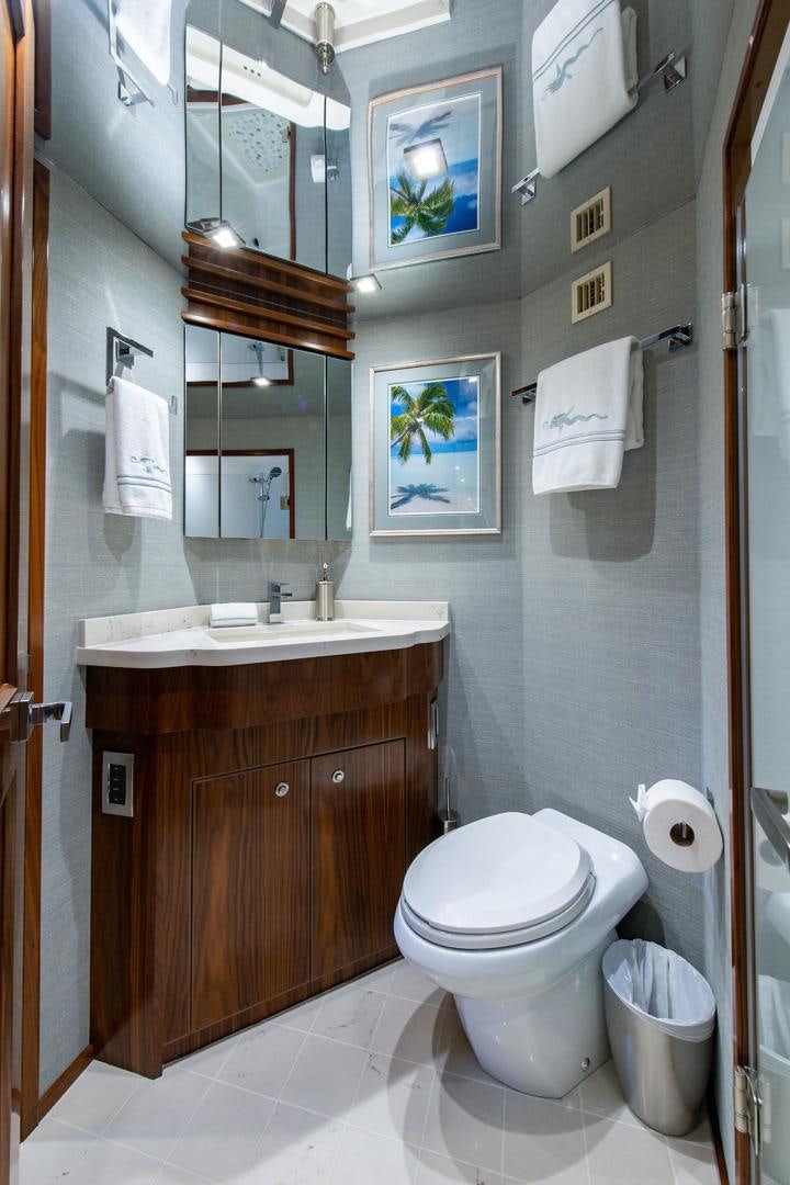 a bathroom with a toilet and a sink aboard OBSESSION Yacht for Sale