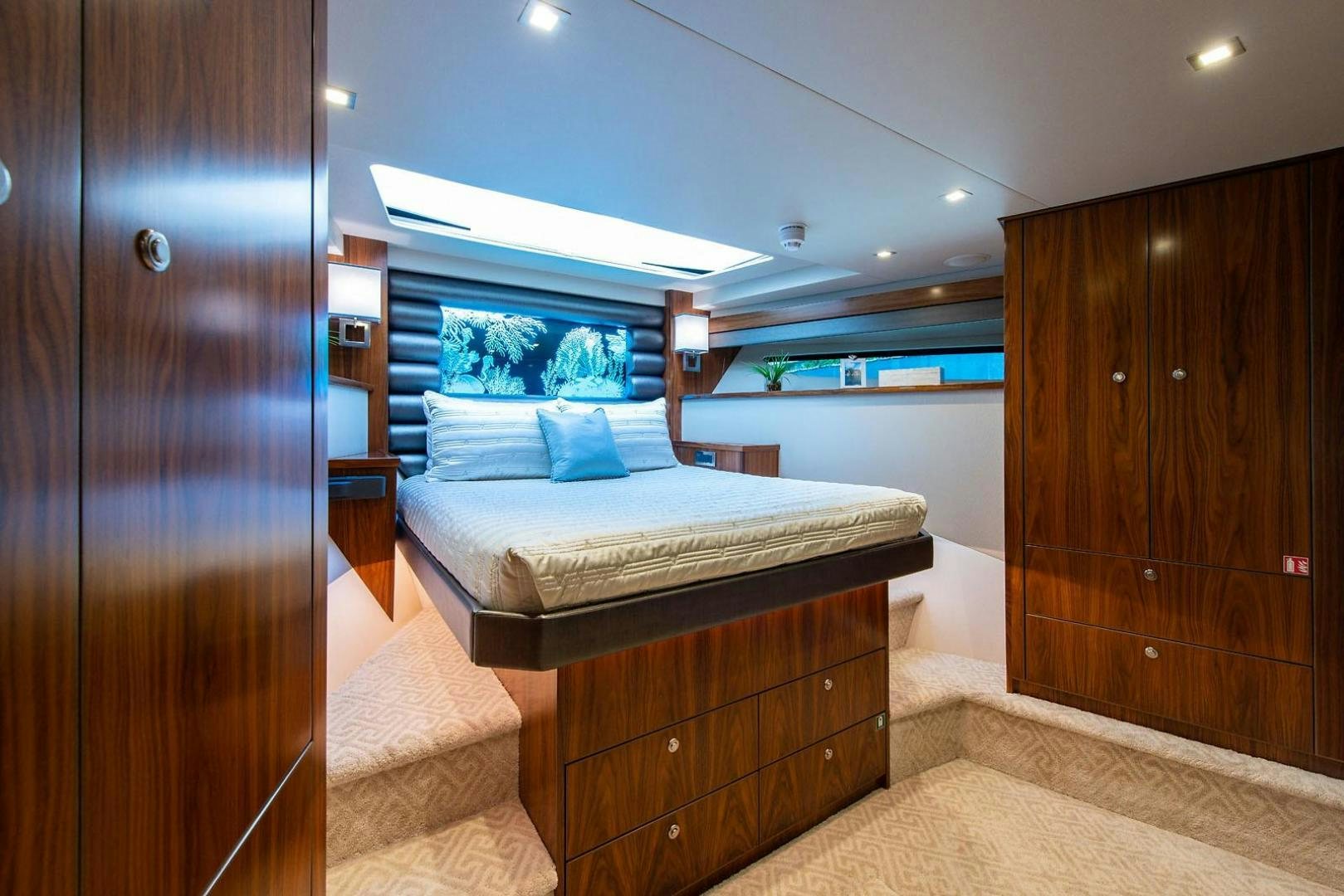 a bedroom with a bed and a closet aboard OBSESSION Yacht for Sale