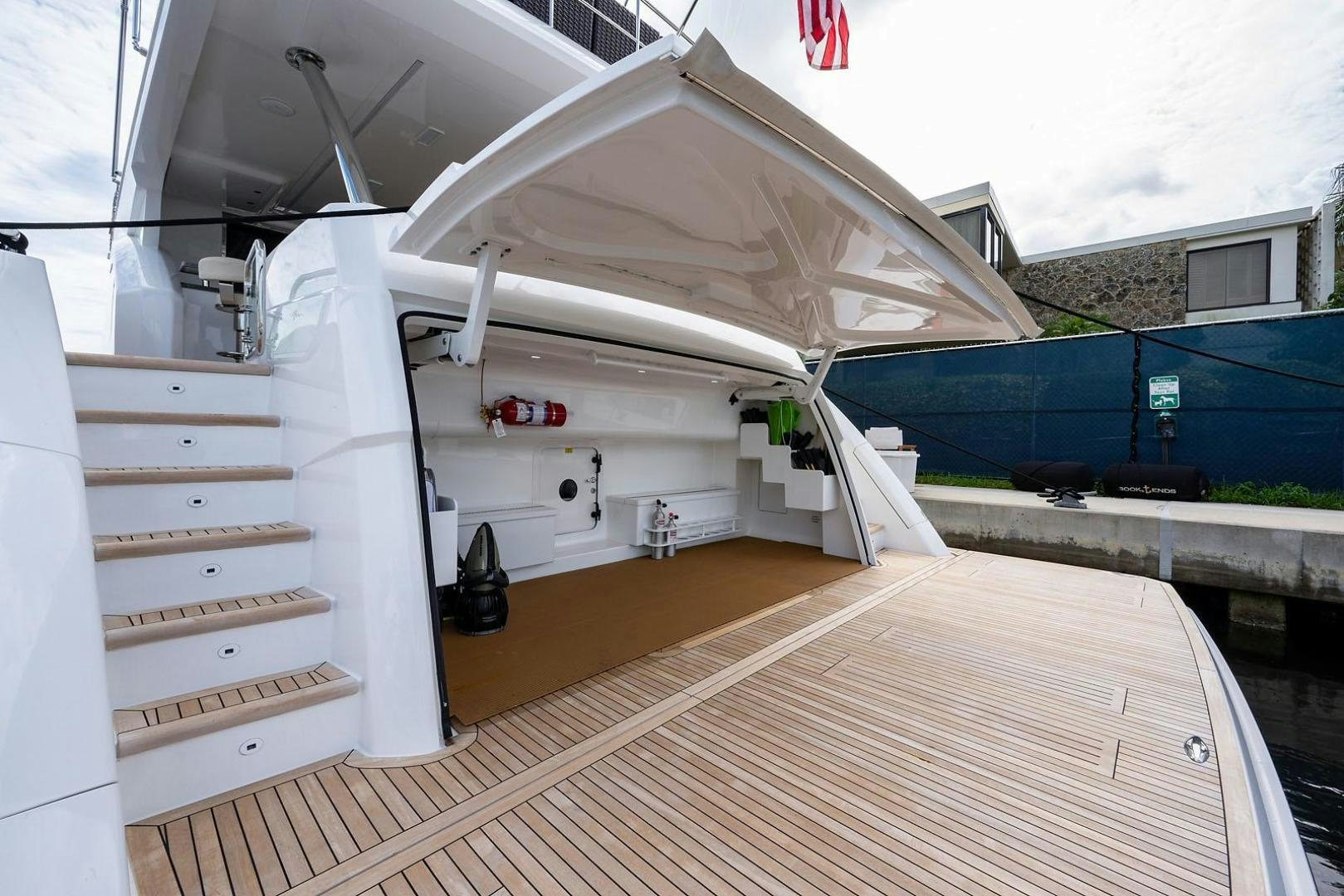 a white boat on a deck aboard OBSESSION Yacht for Sale