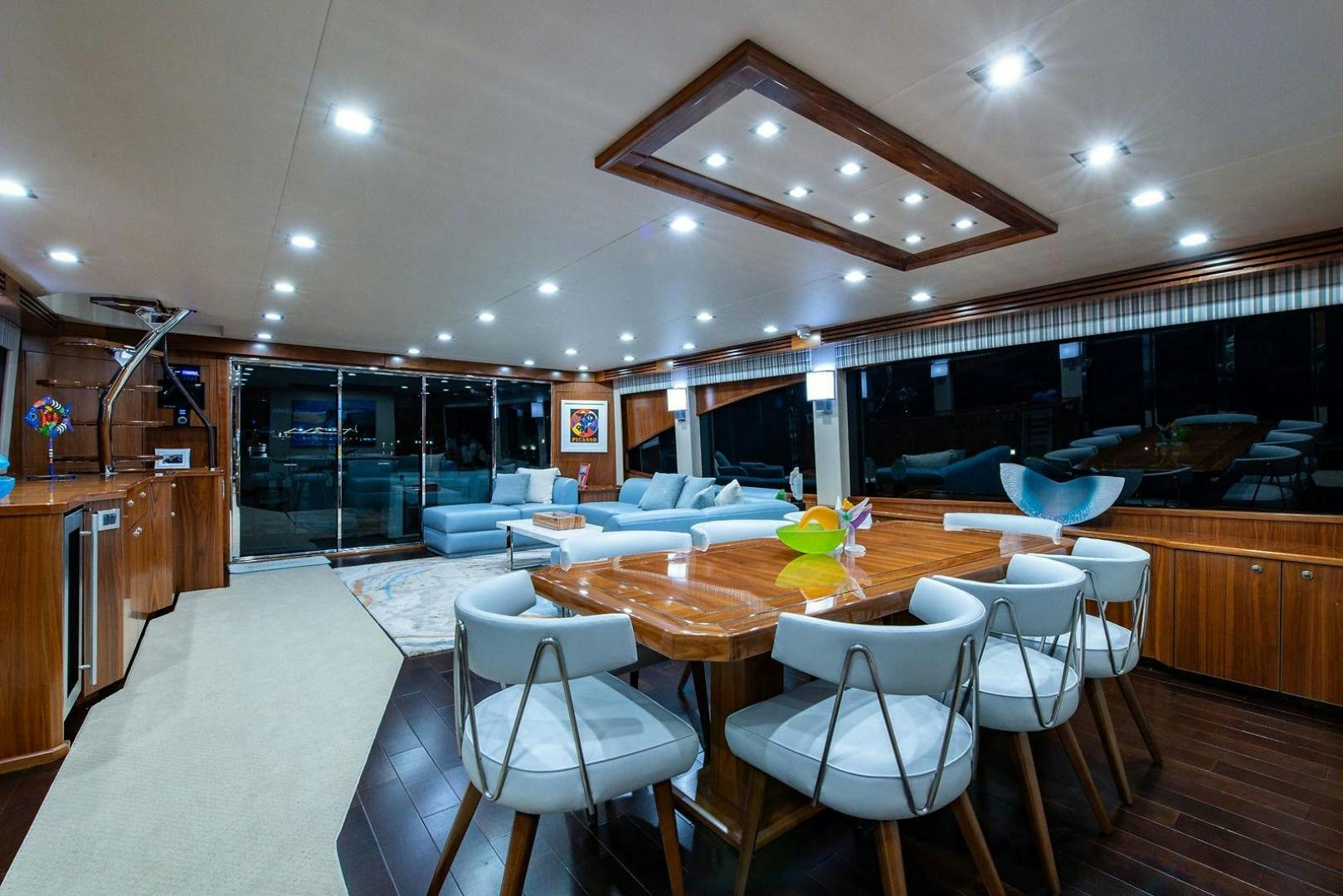 a large room with tables and chairs aboard OBSESSION Yacht for Sale