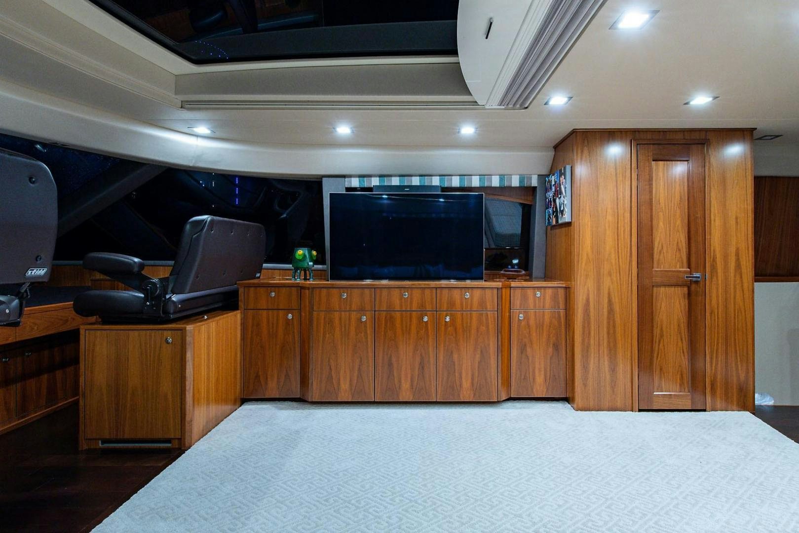 a room with a tv and a cabinet aboard OBSESSION Yacht for Sale