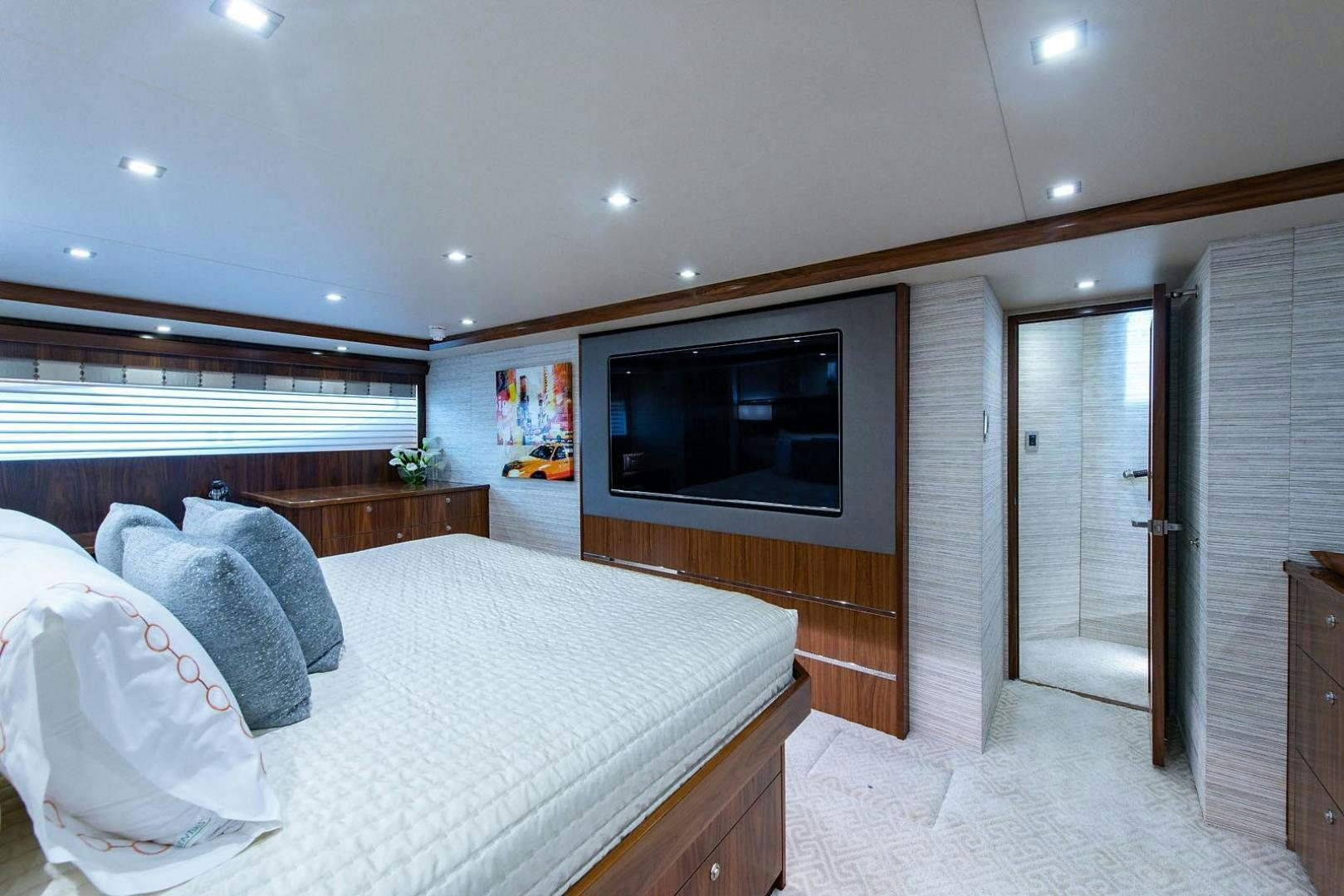 a bedroom with a bed and tv aboard OBSESSION Yacht for Sale