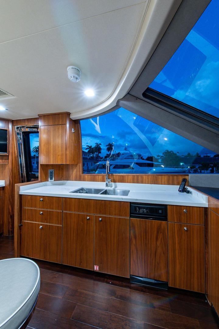 a kitchen with a large window aboard OBSESSION Yacht for Sale