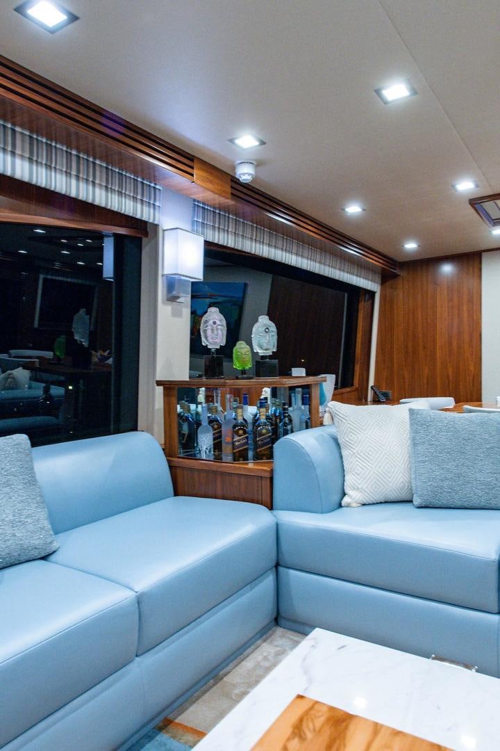 a living room with a couch and a coffee table aboard OBSESSION Yacht for Sale
