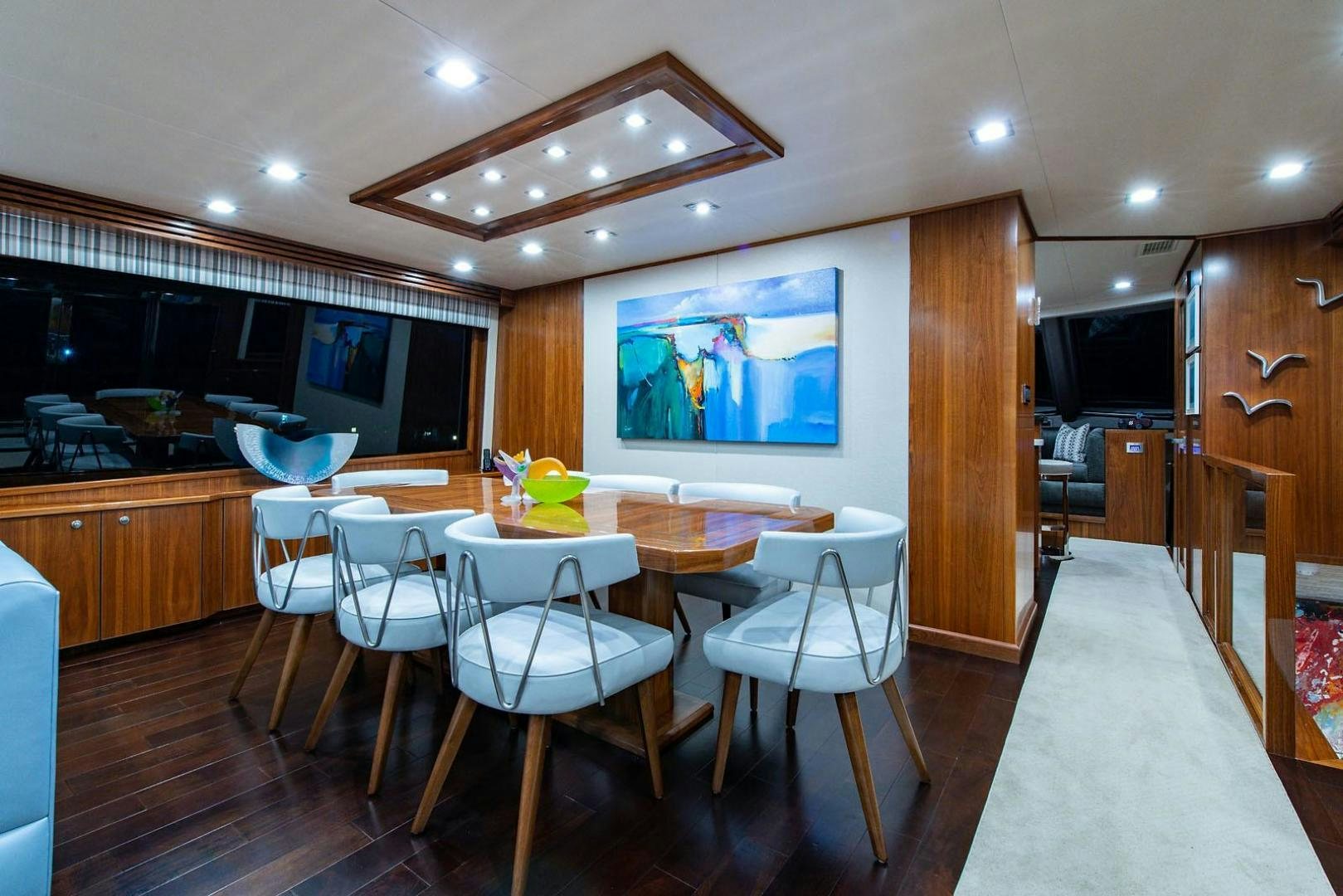 a kitchen with a dining table and chairs aboard OBSESSION Yacht for Sale