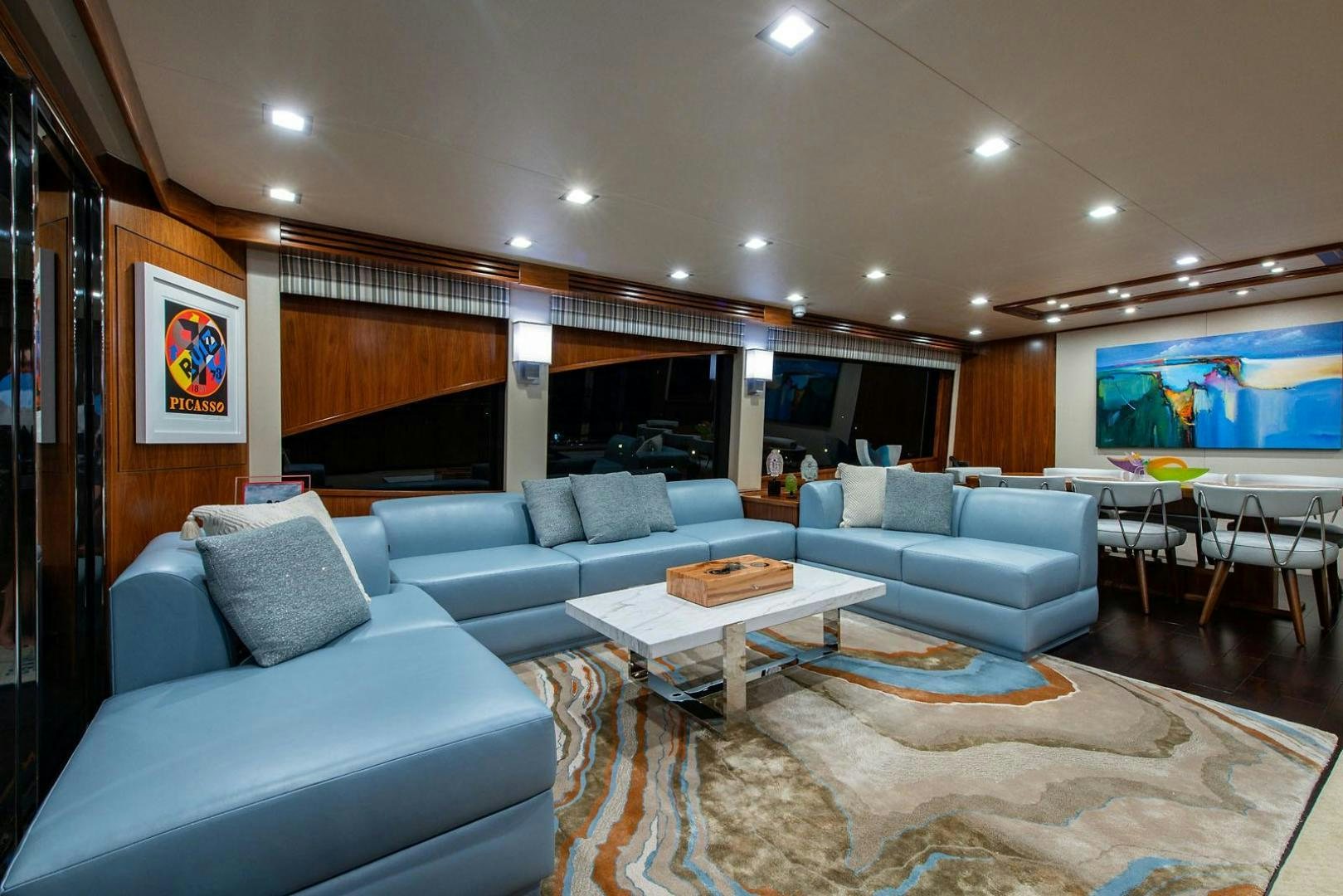 a living room with a large screen aboard OBSESSION Yacht for Sale
