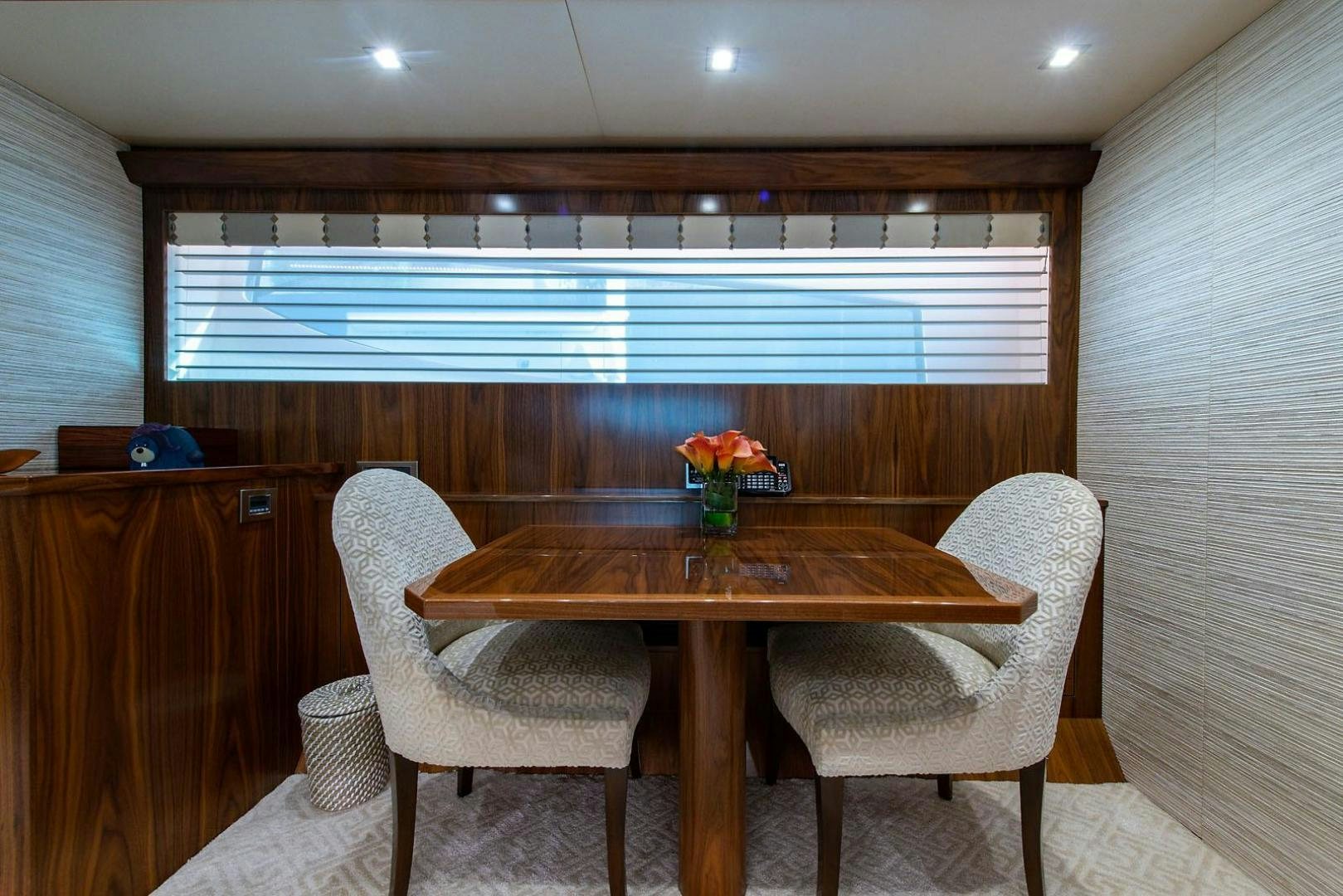 a table and chairs in a room aboard OBSESSION Yacht for Sale