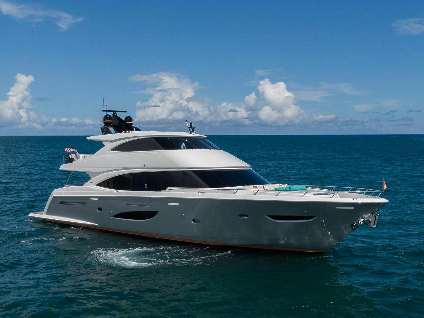 a white yacht in the water aboard OBSESSION Yacht for Sale