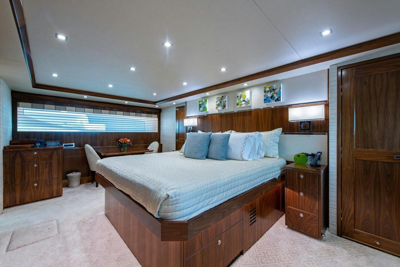 a bedroom with a bed and a desk aboard OBSESSION Yacht for Sale
