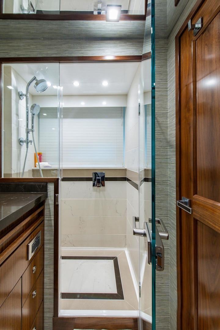 a bathroom with a shower and sink aboard OBSESSION Yacht for Sale